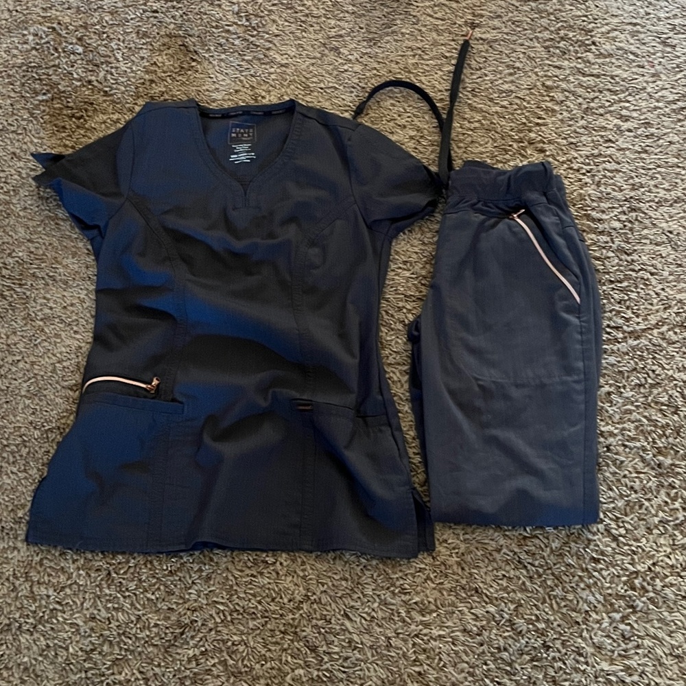 Large lot of scrubs.  Sizes XXS & XS